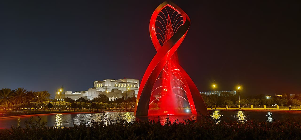 The arches fountain in the gardens of the Royal Opera House in Muscat has been lightened in red